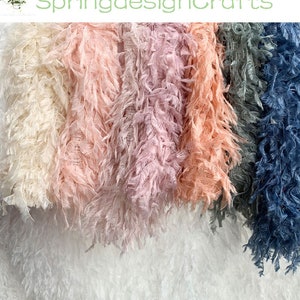 May include: Five different colours of fluffy, feathery fabric. The colours are white, light pink, pink, lavender, and blue.