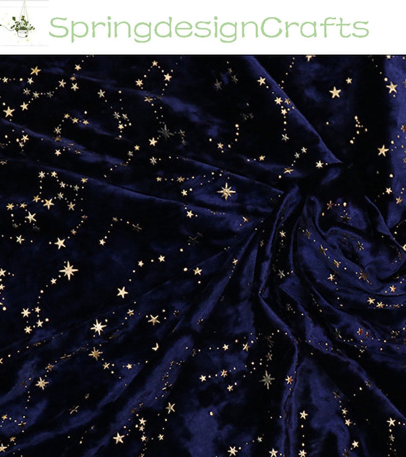 May include: Dark blue velvet fabric with a constellation pattern in gold. The fabric is draped, creating soft folds and shadows. The text "SpringdesignCrafts" is in the upper left corner.