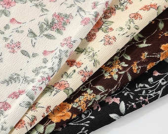 May include: Close-up of four floral fabric swatches. The fabrics feature various floral patterns in cream, brown, and black. The text "Longancraft" is in green script at the top. The fabrics have a ribbed texture.