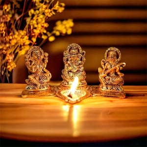Beautiful Metal Lakshmi Ganpati Saraswati Gold Plated  Statute with Oil Lamp DiyaSize :  11 cm X 21 cm X 12 cm