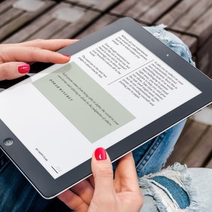 May include: A person is reading an e-book on a tablet. The text on the screen reads "Self-esteem comes from knowing who you are in the world, in your own skin and refusing to be defined by the judgments of others."  The author is Oprah Winfrey.