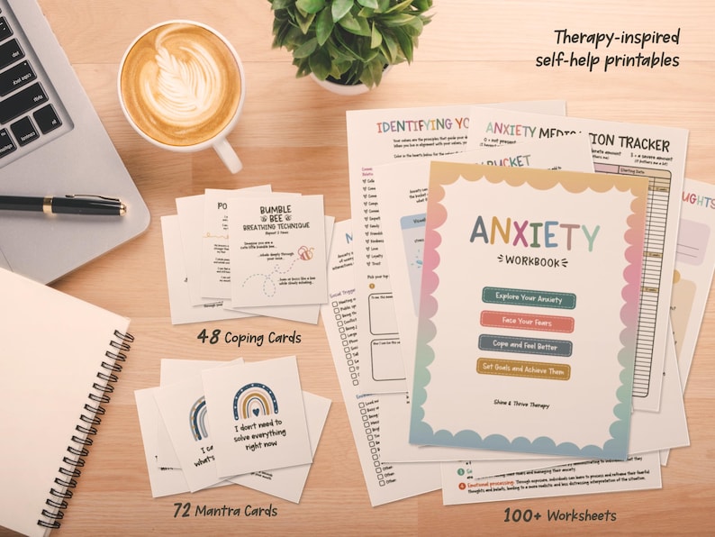 May include: A collection of therapy-inspired self-help printables including an Anxiety Workbook, 48 coping cards, 72 mantra cards, and 100+ worksheets. The workbook cover features a scalloped border and the text Anxiety Workbook with four coloured buttons.