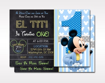 May include: A personalized invitation for a first birthday party featuring a cartoon Mickey Mouse character in a blue onesie. The invitation is decorated with blue, yellow, and gray stripes and polka dots. The text on the invitation reads "El Titi is turning one!" and includes the date, time, location, and RSVP information.