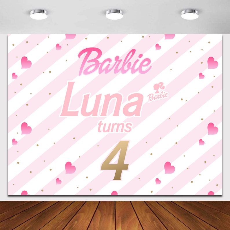 May include: Pink and white striped backdrop with gold glitter dots. The backdrop has the text "Barbie Luna turns 4" with a pink Barbie logo.