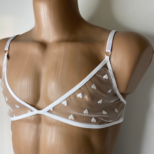 May include: White mesh lingerie top with a white heart pattern and white trim.