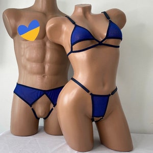 May include: A blue mesh lingerie set with black trim. The set includes a bra with a criss-cross design and a thong with a ring detail.