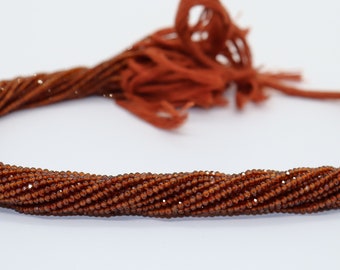 May include: A strand of brown gemstone beads. The beads are faceted and have a shiny finish. The strand is coiled and ready to be used for jewellery making.