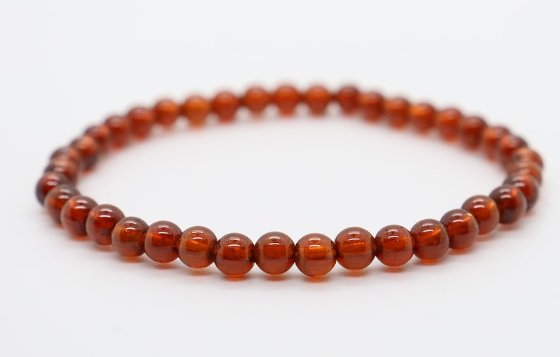 May include: A brown gemstone bracelet with round beads.