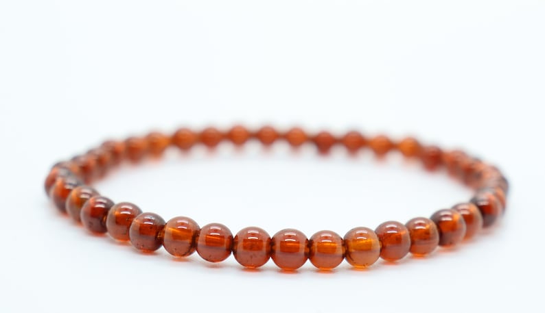 May include: A brown beaded bracelet with round beads.