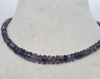 May include: A necklace made of small, faceted, dark purple gemstones. The necklace is strung on a thin, silver chain.