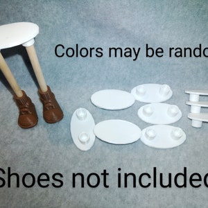 May include: A white miniature table with wooden legs and brown boots, along with several white platforms. The text "Colors may be random" and "Shoes not included" are also present.