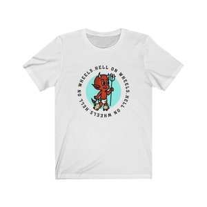 May include: White t-shirt featuring a cartoon devil with a trident, set within a teal circle. The text "HELL ON WHEELS" encircles the graphic. The devil is red with horns and is wearing a diaper.