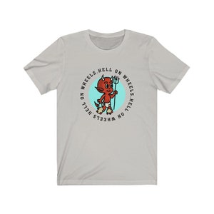 May include: Light gray t-shirt featuring a cartoon devil with a trident, roller skates, and the text "HELL ON WHEELS" in a circular design. The devil is red with white horns and a diaper. The shirt is made of a soft material.