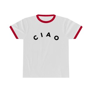 May include: White t-shirt with a red trim on the collar and sleeves. The word "CIAO" is printed in black across the front of the shirt. The shirt is made of a soft, comfortable material.