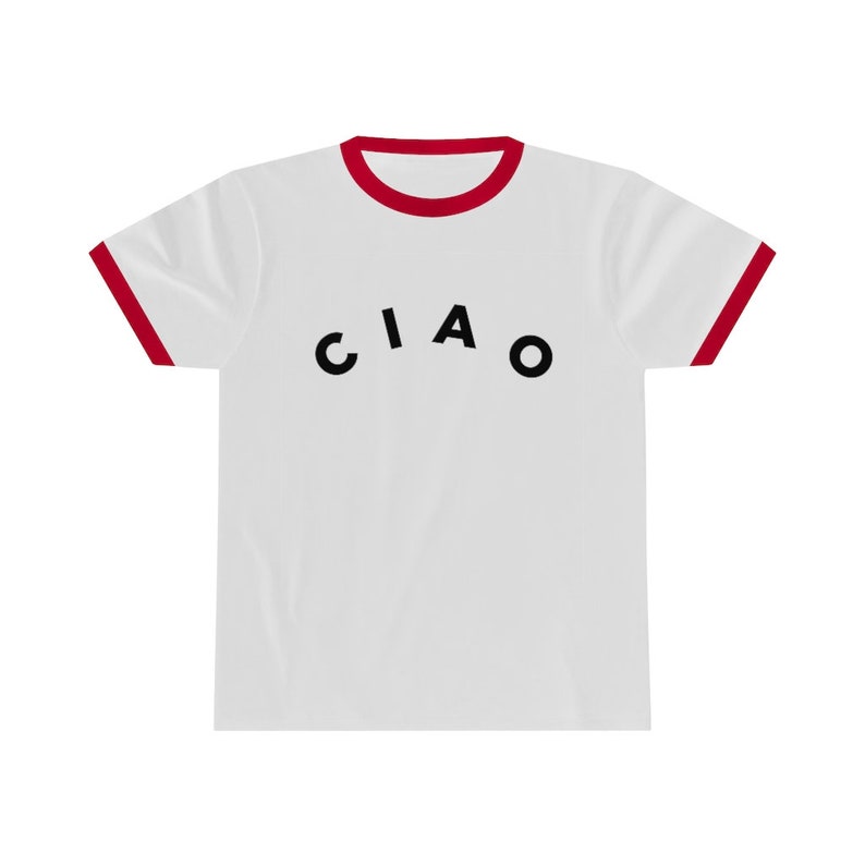 May include: White t-shirt with a red trim on the collar and sleeves. The word "CIAO" is printed in black across the front of the shirt. The shirt is made of a soft, comfortable material.