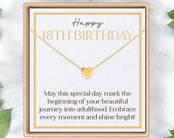 May include: A gold heart necklace in a gift box with a card that reads "Happy 18th Birthday. May this special day mark the beginning of your beautiful journey into adulthood. Embrace every moment and shine bright!"