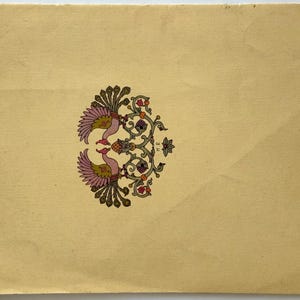 May include: A cream-colored paper with a symmetrical design of two birds facing each other. The birds have pink and yellow feathers, with a floral and vine pattern in green, orange, and purple. The paper has a vintage look.