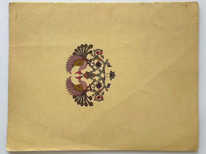 May include: A cream-colored paper with a symmetrical design of two birds facing each other. The birds have pink and yellow feathers, with a floral and vine pattern in green, orange, and purple. The paper has a vintage look.