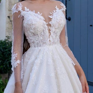 Romantic Long Sleeve A-Line Wedding Dress with 3D Floral Lace and Sparkle Tulle – Illusion Neckline Bridal Gown with Train