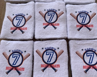 May include: Eight white wristbands with a baseball theme. Each wristband has a blue and orange circle with the number 7 in the center. The text "Zach's Birthday!" is printed on each wristband.