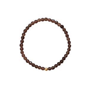 Könnte beinhalten: Ein Armband aus braunen Edelsteinperlen mit einem goldenen Perlenakzent.