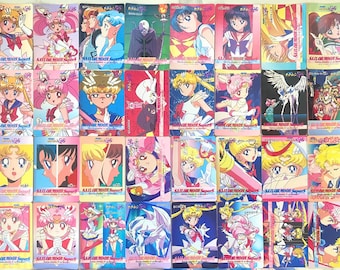 May include: A collection of thirty-two rectangular Sailor Moon SuperS trading cards featuring various anime characters, including Sailor Moon, Chibi Moon, and Pegasus, with vibrant illustrations, Japanese text, and the Sailor Moon SuperS logo.