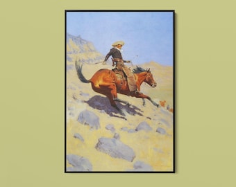 Può includere: Una stampa d'arte incorniciata che raffigura un cavaliere con un cappello a tesa larga e abiti scuri in sella a un cavallo marrone che galoppa su un terreno roccioso e arido. La scena presenta un cielo azzurro sopra un paesaggio con massi grigi.