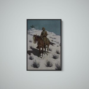 May include: Framed artwork depicting a person on horseback in a snowy landscape. The rider, dressed in a long coat and hat, holds a rifle. The horse is brown with a white blaze. A second rider is visible in the background.