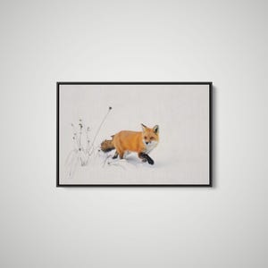 May include: A framed wall art print featuring a vibrant red fox walking through deep white snow. The fox has a thick orange coat, black-tipped ears, and dark paws. Beside the fox are thin, dried stalks of grass protruding from the snow.