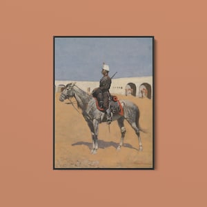 May include: A framed painting depicting a mounted soldier in a dark uniform and white helmet riding a grey horse across a sandy landscape. The background features a white wall with arched openings under a pale blue sky, rendered in oil paint.