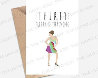May include: A white greeting card with the black text THIRTY FLIRTY & THRIVING. Below the text is a colorful illustration of a person wearing a multi-colored dress with green, blue, red, and purple stripes, standing next to a brown envelope.