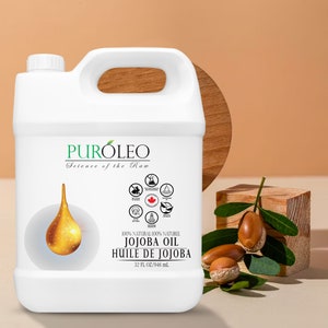 May include: A white plastic jug with a handle containing 946 ml of 100% natural jojoba oil. The label reads "PURÓLEO Science of the Raw 100% NATURAL/100% NATUREL JOJOBA OIL HUILE DE JOJOBA 32 FL OZ/946 mL".