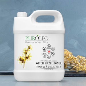 May include: A white plastic jug with a black label that reads "PURÓLEO Science of the Raw 100% NATURAL/100% NATUREL WITCH HAZEL TONER TONIQUE À L'HAMAMÉLIS 32 FL OZ/946 ML". The label also features a drawing of a witch hazel plant and a circle of icons.