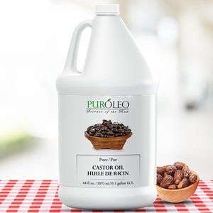May include: A white plastic jug of castor oil with a handle, labeled "PUR&Oacute;LEO." The label includes text in English and French, and a graphic of castor beans in a wooden bowl. A small wooden bowl of castor beans sits to the right.