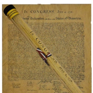 May include: A rolled-up document with a red, white, and blue ribbon, and the text "IN CONGRESS, JULY 4, 1776." The document is labeled "Declaration of Independence".