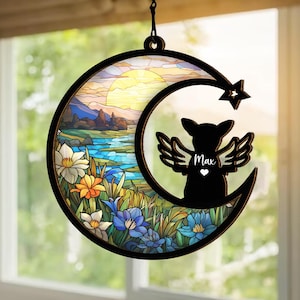 May include: A stained glass style moon with a sunset scene and flowers. A black silhouette of a dog with angel wings is in the moon. The dog's name "Max" is written on the image.