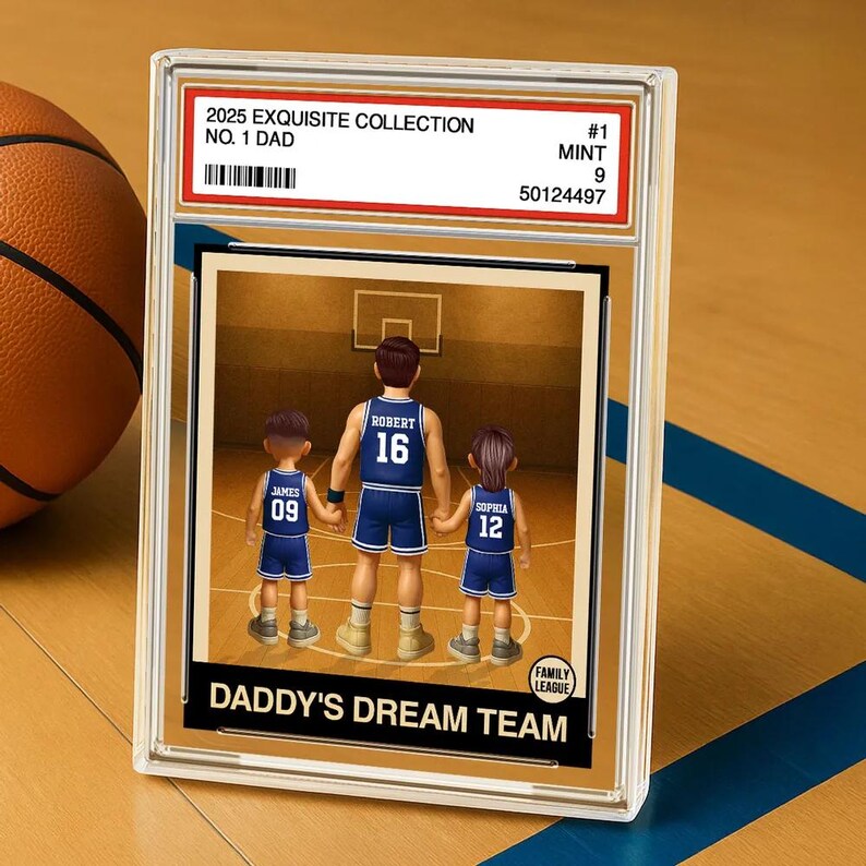 May include: A basketball card with a cartoon illustration of a family of three playing basketball. The card is titled "Daddy's Dream Team" and has the text "2025 Exquisite Collection, No. 1 Dad, #1, Mint 9, 50124497" on the top. The players are wearing blue and white jerseys with their names and numbers on the back.