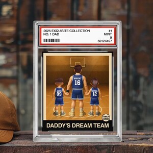 May include: A basketball card featuring a cartoon illustration of a family of three playing basketball. The father is wearing a blue jersey with the number 16, the son is wearing a blue jersey with the number 9, and the daughter is wearing a blue jersey with the number 12. The card is titled "Daddy's Dream Team" and has the text "2025 Exquisite Collection No. 1 Dad #1 Mint 9 50124497" on the top.