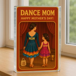 May include: A red, white, and blue illustrated card with the text "Dance Mom Happy Mother's Day!"  Two figures in dance costumes stand on a stage. The woman's costume says "Mom" and the girl's costume says "Sophia".