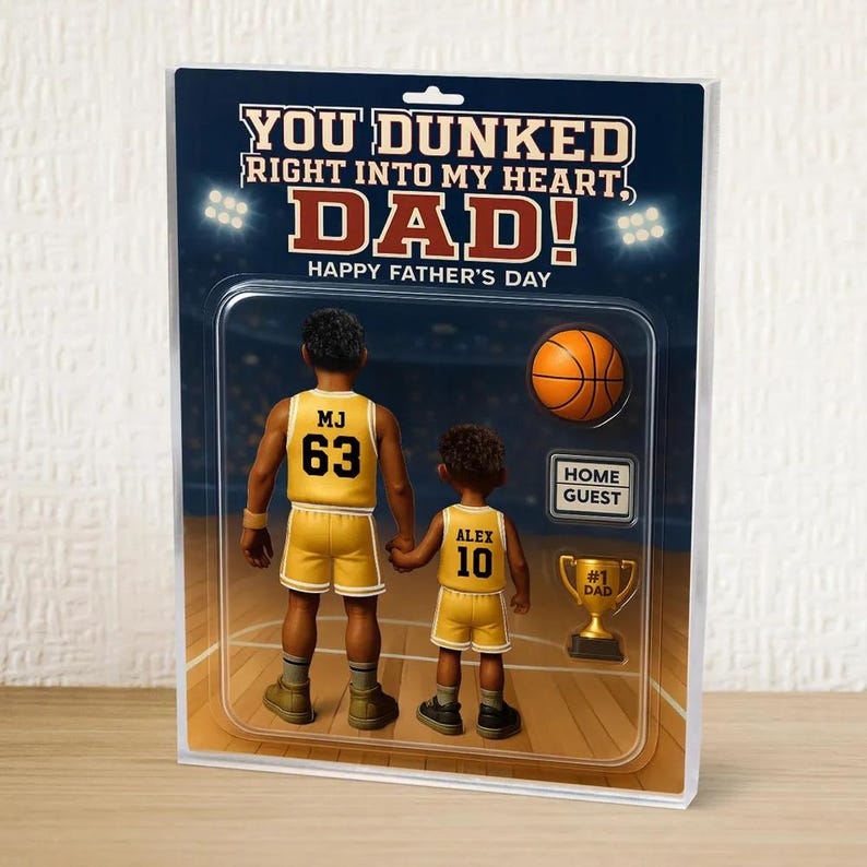 May include: A Father's Day card featuring a cartoon illustration of two basketball players, one with the name "MJ" and the number "63" on their jersey, and the other with the name "Alex" and the number "10". The card has the text "You dunked right into my heart, Dad! Happy Father's Day".