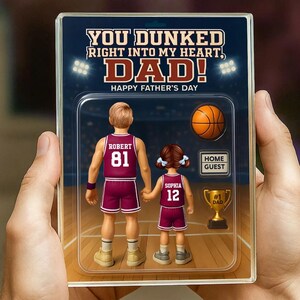 May include: A personalized Father's Day card featuring a cartoon illustration of a basketball player with the text "YOU DUNKED RIGHT INTO MY HEART, DAD! HAPPY FATHER'S DAY". The card also includes a basketball, a trophy, and a sign that says "HOME GUEST".