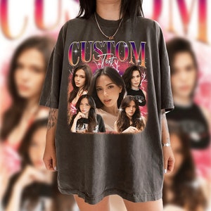May include: A dark gray oversized t-shirt with a vintage-style graphic print featuring multiple images of women and the text "CUSTOM Text".
