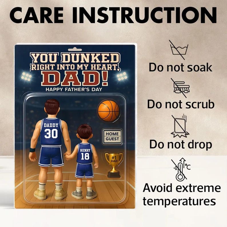May include: A Father's Day card featuring a cartoon illustration of a father and son playing basketball. The card has the text "You dunked right into my heart, Dad! Happy Father's Day" and includes care instructions for the card.
