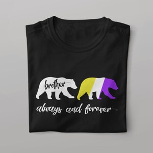 May include: Black t-shirt featuring two bear silhouettes. One bear is white, and the other is colored with the non-binary pride flag. The words "brother always and forever" are written in white script below the bears.