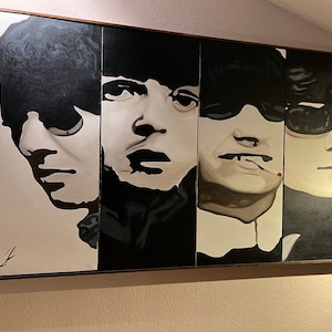 May include: A black and white painting of four men's faces. The men are wearing hats and sunglasses. The painting is in a wooden frame.