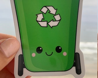 May include: A green sticker of a cartoon recycling bin with a smiling face, black eyes, and pink cheeks. The recycling symbol is in the center. The bin has black wheels and a white border.