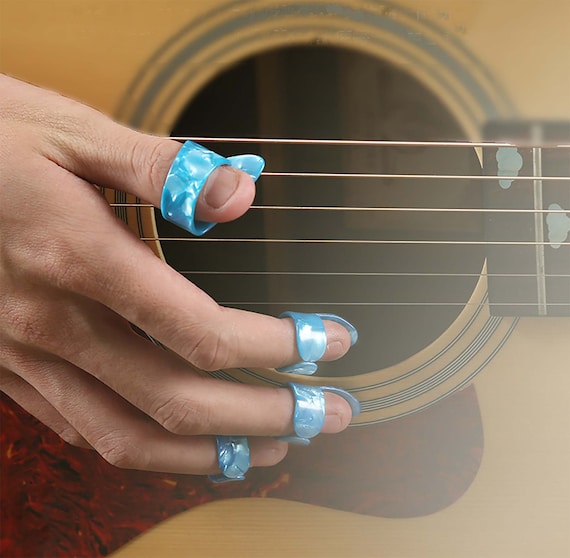 Premium Photo | Young girl with long nails plays acoustic guitar at home  teenager sits on couch in room and learns to play guitar