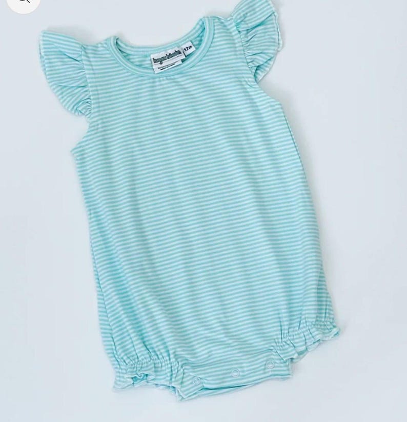 May include: A light blue and white striped baby romper with ruffled sleeves and leg openings. The romper has a round neckline and a label that reads "Jacques Marchais 12m". The fabric is soft and lightweight, perfect for warm weather.