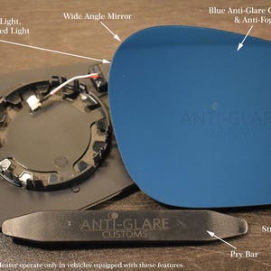 May include: An exploded view of a car side mirror replacement kit. The kit includes a blue anti-glare mirror, a black mounting plate with a mirror heater, and a pry bar. The mirror reflects 60% of blue light and lowers yellow and red light.
