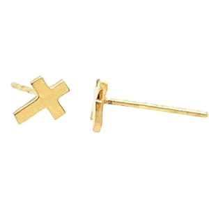May include: A pair of gold cross stud earrings. The earrings are small and simple, making them a great choice for everyday wear.